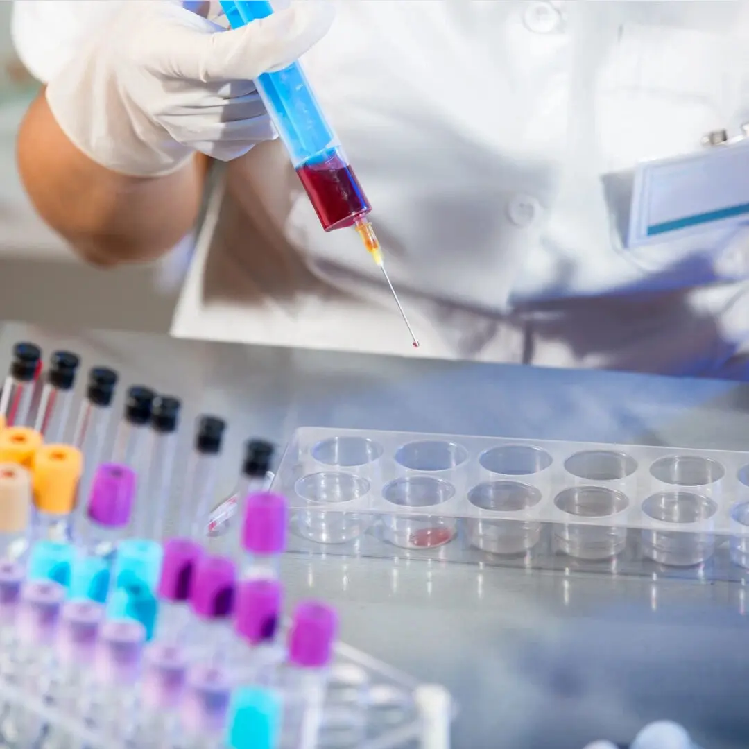 A laboratory technician putting injected blood sample into a container